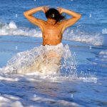 young nude woman atthe beach