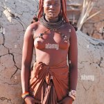 Himba woman Himba village Purros Kaokoland Kunene Region Namibia Africa Travel Nature nude breasts portrait Stock Photo