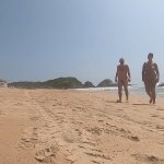Walking nude freely having fun on public nudist beach